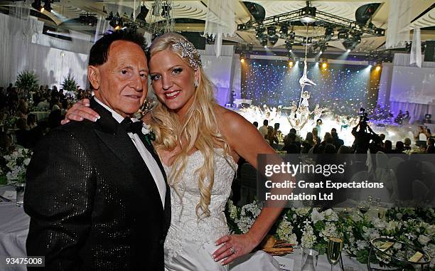 Bride Brynne Gordon and groom Geoffrey Edelsten pose for a photograph during the performance by Urban Cirque at the wedding of Geoffrey Edelsten and...