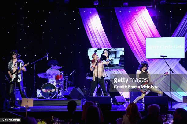 Dabney Tellum, Hugh Jass and Moe Lato of The Wayward Sons perform on stage during the Venice Family Clinic Silver Circle Gala at The Beverly Hilton...