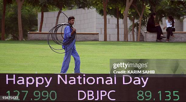 Worker walks outside the Dubai International Financial Center in the Gulf emirate on November 29, 2009. Dubai's shock alert of possible debt default...