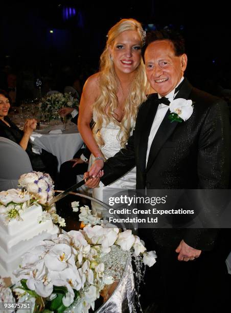 Bride Brynne Gordon and groom Geoffrey Edelsten pose for a photograph as they cut the wedding cake during the wedding of Geoffrey Edelsten and Brynne...