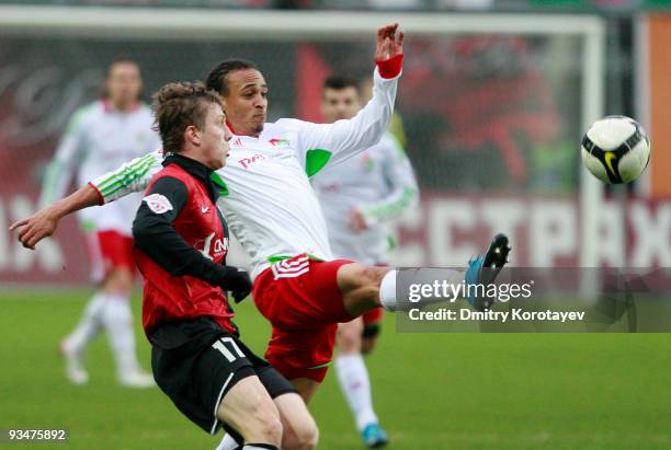 Yevgeni Gapon of FC Khimki fights for the ball with Peter Odemwingie of FC Lokomotiv Moscow during the Russian Football League Championship match...