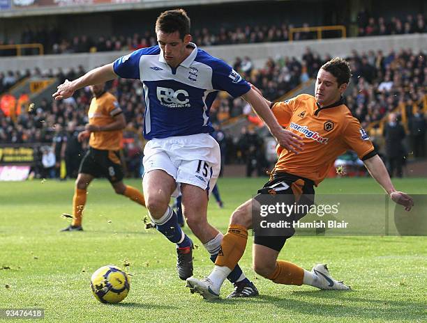 Scott Dann of Birmingham is tackled by Matt Jarvis of Wolverhampton during the Barclays Premier League match between Wolverhampton Wanderers and...