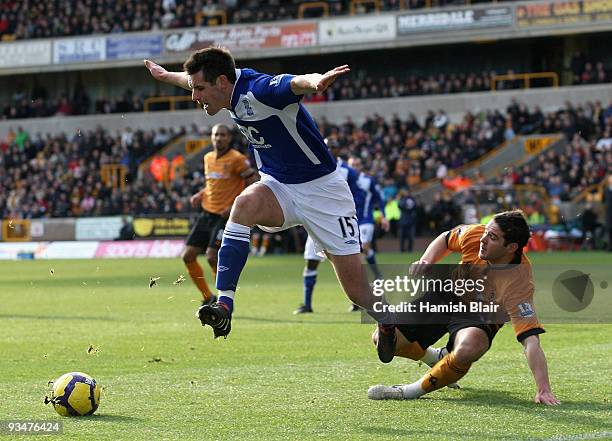 Scott Dann of Birmingham is tackled by Matt Jarvis of Wolverhampton during the Barclays Premier League match between Wolverhampton Wanderers and...