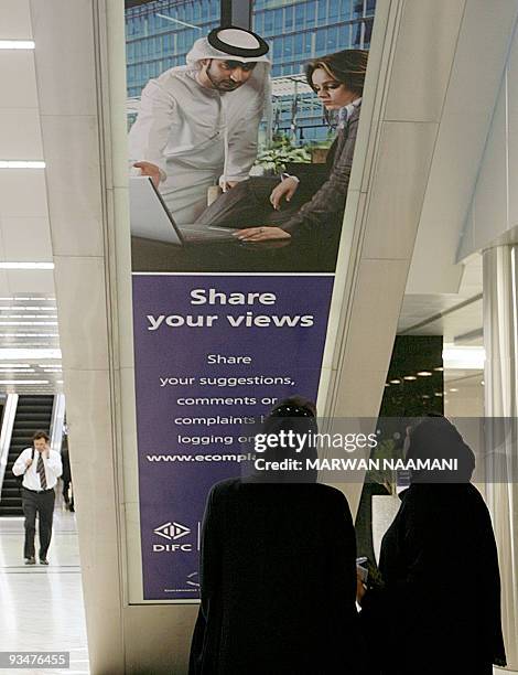 Two UAE women chat in the Dubai International Financial Centre , "The Gate", pictured on July 10, 2008 is the first building in the Dubai Financial...