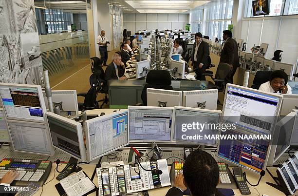 Arab and Foreign employees work at the Standard Chartered Bank's new trading room at the Dubai International Financial Center , April 28 2008....