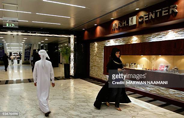 Dubai beauty passes next to a boutique in the Dubai International Financial Centre , "The Gate", pictured on July 10, 2008 is the first building in...