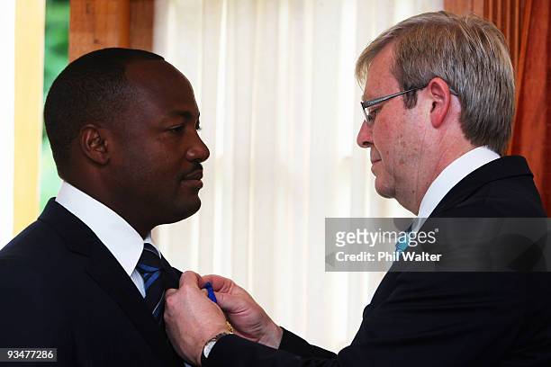 Australian Prime Minister Kevin Rudd presents former West Indies cricketer Brian Lara with the insignia of the Order of Australia during a ceremony...