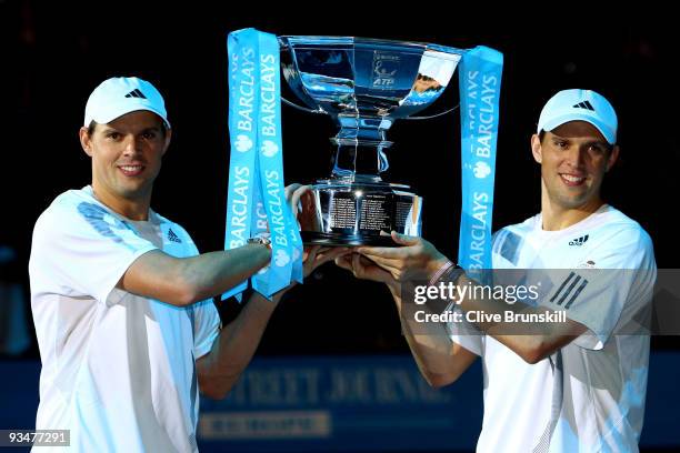 Bob Bryan of USA and Mike Bryan hold the trophy as they celebrate winning the men's doubles final match against Max Mirnyi of Belarus and Andy Ram of...