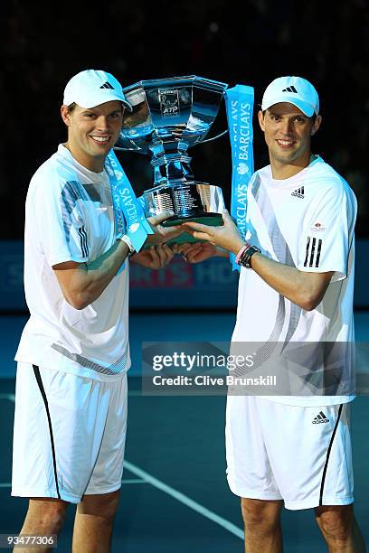 Bob Bryan of USA and Mike Bryan hold the trophy as they celebrate winning the men's doubles final match against Max Mirnyi of Belarus and Andy Ram of...