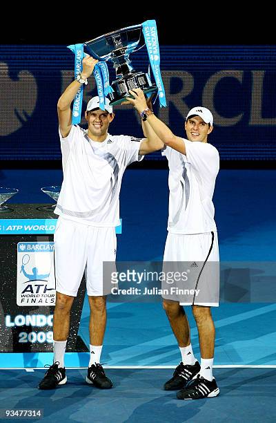 Bob Bryan of USA and Mike Bryan hold the trophy as they celebrate winning the men's doubles final match against Max Mirnyi of Belarus and Andy Ram of...