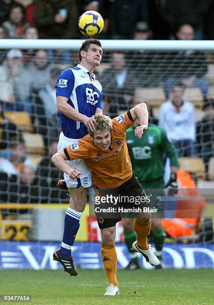 Scott Dann of Birmingham contests with Kevin Doyle of Wolverhampton during the Barclays Premier League match between Wolverhampton Wanderers and...