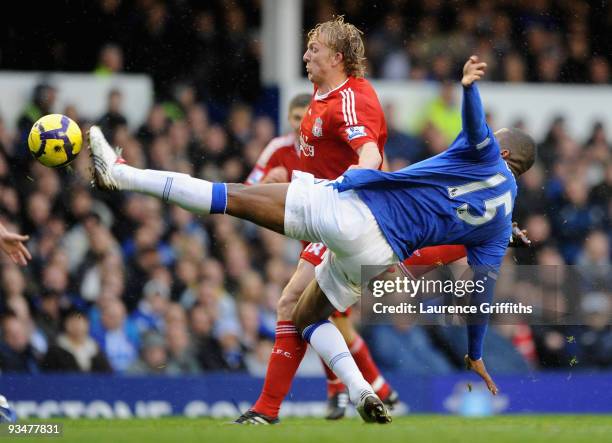 Sylvain Distin of Everton challenges Dirk Kuyt of Liverpool during the Barclays Premier League match between Everton and Liverpool at Goodison Park...