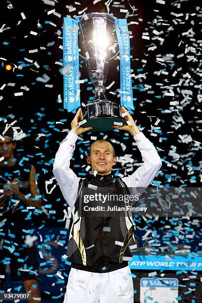 Nikolay Davydenko of Russia holds the trophy as he celebrates winning the men's singles final match against Juan Martin Del Potro of Argentina during...