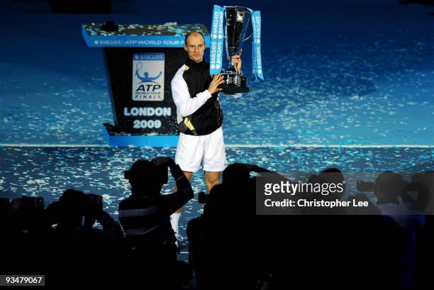 Nikolay Davydenko of Russia holds the trophy as he celebrates winning the men's singles final match against Juan Martin Del Potro of Argentina during...