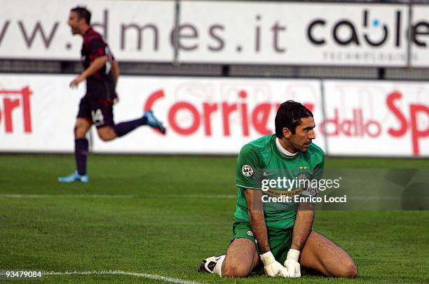 Juventus goalkeeper Gianluigi Buffon looks back at the goal he conceded to Alessandro Matri of Cagliari, while Francesco Pisano of Cagliari...