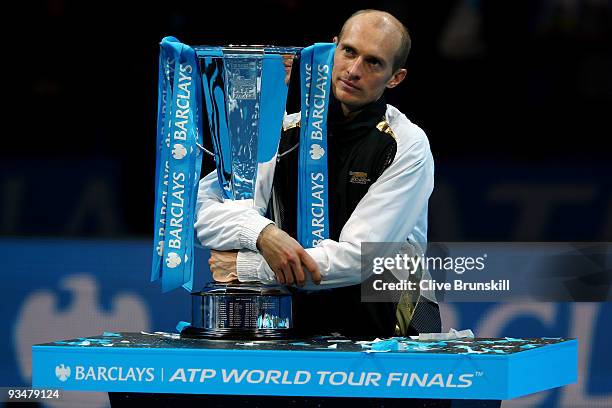 Nikolay Davydenko of Russia holds the trophy as he celebrates winning the men's singles final match against Juan Martin Del Potro of Argentina during...