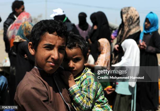 Yemeni children wait their turn to fill their jerrycans with water on March 18, 2018 in Sana'a, Yemen.