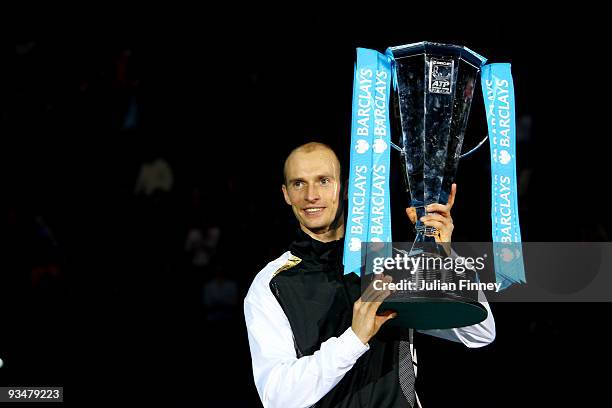 Nikolay Davydenko of Russia holds the trophy as he celebrates winning the men's singles final match against Juan Martin Del Potro of Argentina during...