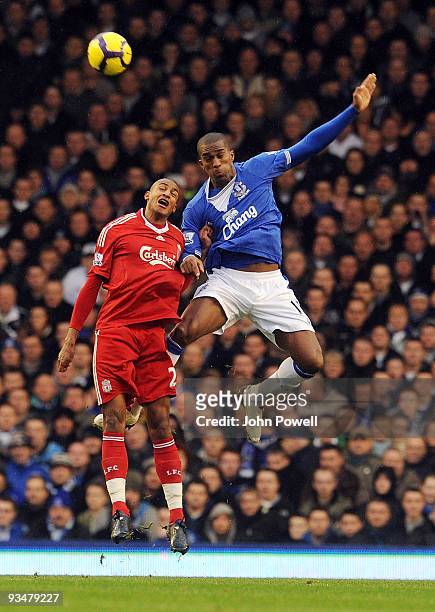 David Ngog of Liverpool goes up with Sylvain Distin of Everton during the Barclays Premier League match between Everton and Liverpool at Goodison...