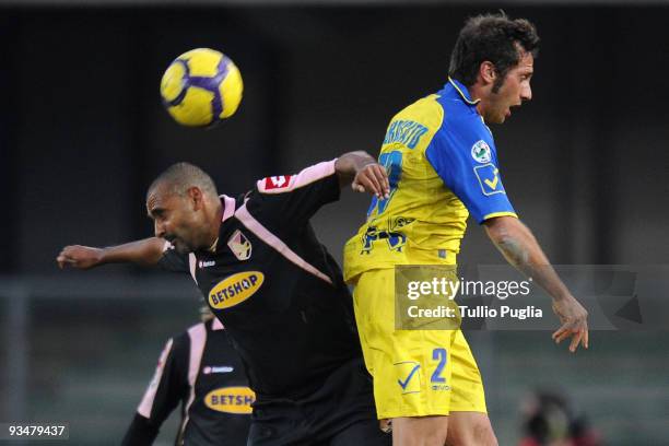 Fabio Liverani of Palermo and Elvis Abbruscato of Chievo compete for a header during the Serie A match between AC Chievo Verona and US Citta di...