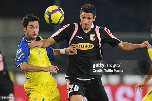 Igor Budan of Palermo and Andrea Mantovani of Chievo compete for the ball during the Serie A match between AC Chievo Verona and US Citta di Palermo...