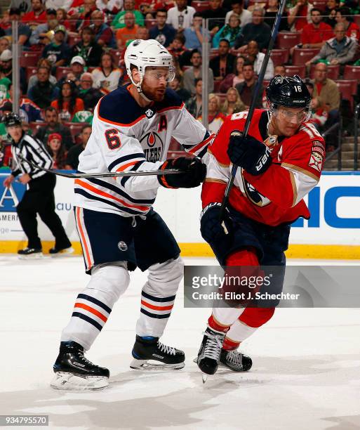 Adam Larsson of the Edmonton Oilers shoves Aleksander Barkov of the Florida Panthers at the BB&T Center on March 17, 2018 in Sunrise, Florida.