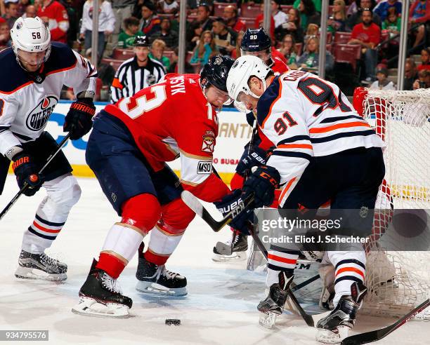 Drake Caggiula of the Edmonton Oilers tangles with Mark Pysyk of the Florida Panthers at the BB&T Center on March 17, 2018 in Sunrise, Florida.