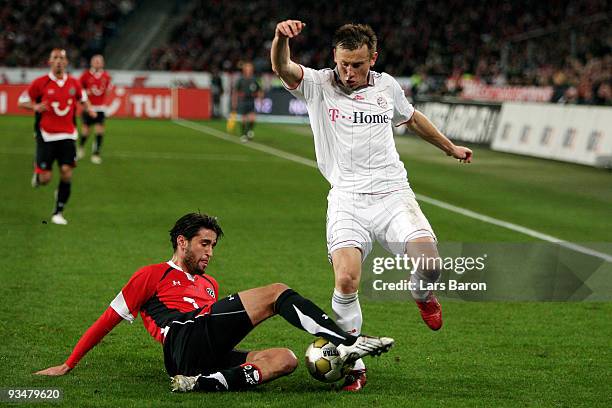 Karim Haggui of Hannover challenges Ivica Olic of Muenchen during the Bundesliga match between Hannover 96 and FC Bayern Muenchen at AWD-Arena on...