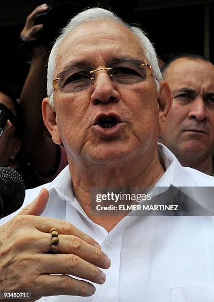 Honduran de facto president Roberto Michelleti speaks with journalists after casting his vote in general elections, in El Progreso about 300 km north...