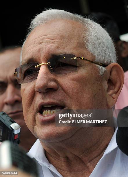 Honduran de facto president Roberto Michelleti speaks with journalists after casting his vote in general elections, in El Progreso about 300 km north...