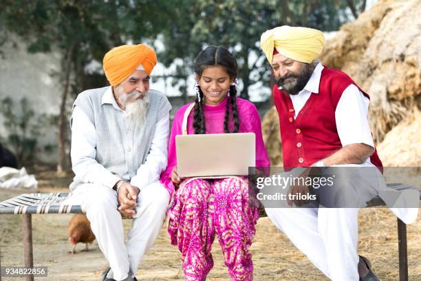 indian men with girl using laptop - turban family stock pictures, royalty-free photos & images