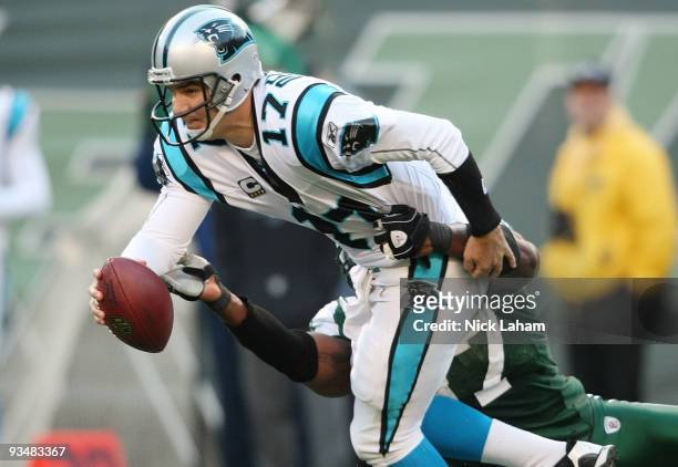 Jake Delhomme of the Carolina Panthers is sacked by Calvin Pace of the New York Jets at Giants Stadium on November 29, 2009 in East Rutherford, New...
