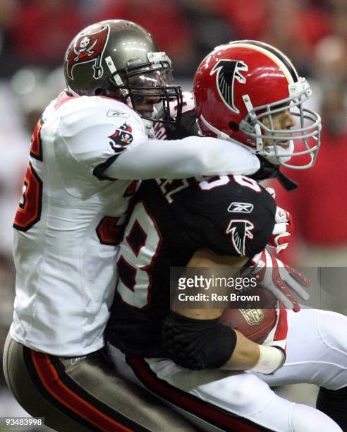 Tony Gonzalez of the Atlanta Falcons is brought down by Tanard Jackson of the Tampa Bay Buccaneers at the Georgia Dome on November 29, 2009 in...