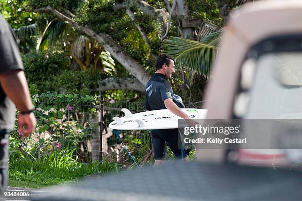 Joel Parkinson of Australia walks home after early morning surfing during the O'Neill World Cup of Surfing on November 29, 2009 in Sunset Beach,...