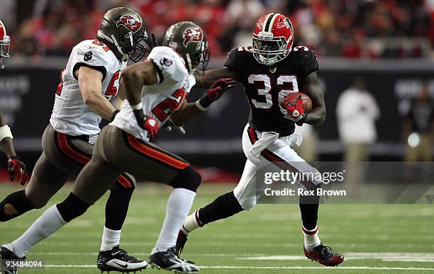 Jerious Norwood of the Atlanta Falcons works to pick up a first down as he attempts to get around Barrett Ruud of the Tampa Bay Buccaneers at the...