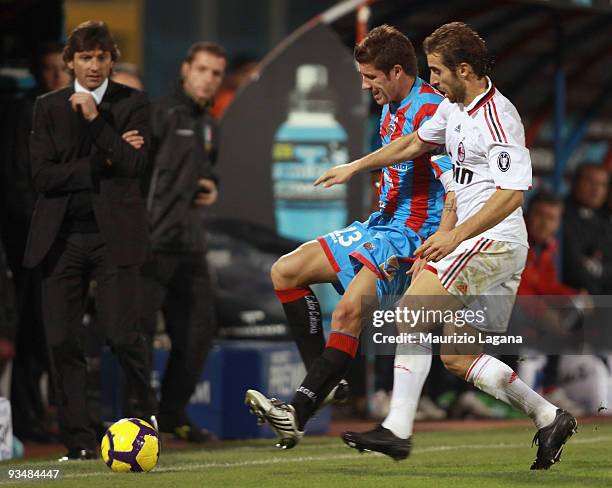 Mariano Izco of Catania Calcio battles for the ball with Mathieu Flamini of AC Mialn during the Serie A match between Catania Calcio and AC Milan at...