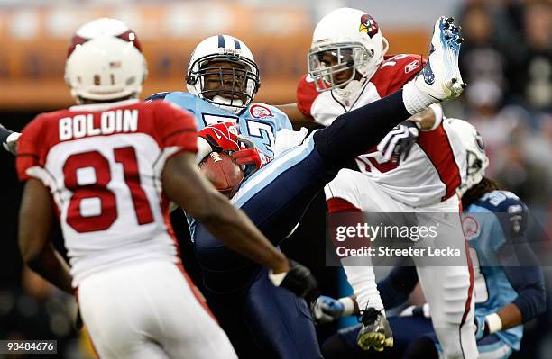 Steve Breaston of the Arizona Cardinals breaks up a pass with Keith Bulluck of the Tennessee Titans during their game at LP Field on November 29,...