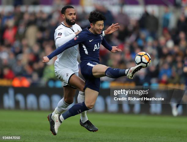 Heung-Min Son of Tottenham Hotspur is challenged by Kyle Bartley of Swansea City during The Emirates FA Cup Quarter Final match between Swansea City...