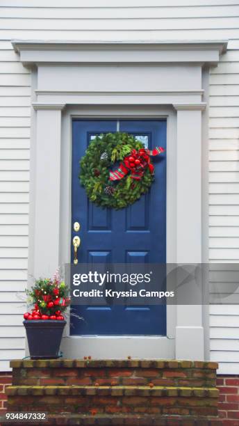 beautiful blue front door decorated for christmas - front door stock pictures, royalty-free photos & images