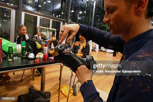 Dancer cleans his dance shoes during a break at the World Latin Dance Masters 2009 at the Innsbruck Congress hall on November 28, 2009 in Innsbruck,...