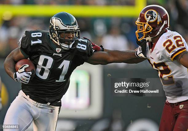 Wide Receiver Jason Avant of the Philadelphia Eagles stiff arms cornerback Carlos Rogers of the Washington Redskins on November 29, 2009 at Lincoln...