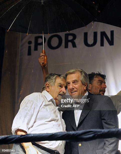 Uruguayan president elect, former guerrilla Jose Mujica of the ruling Frente Amplio party, speaks with Uruguayan President Tabare Vazquez during a...