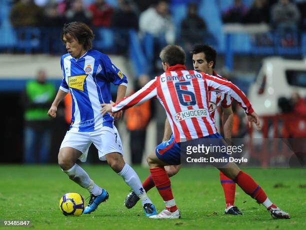 Shunsuke Nakamura of Espanyol is tackled by Ignacio Camacho of Atletico Madrid during the La Liga match between Espanyol and Atletico Madrid at the...