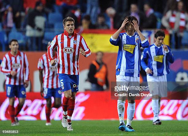 Shunsuke Nakamura of Espanyol reacts beside Ignacio Camacho after Atletico Madrid scored their fourth goal during the La Liga match between Espanyol...