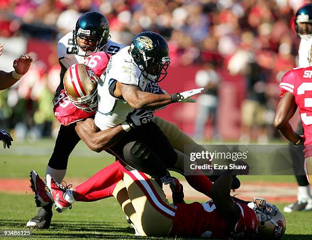 Maurice Jones-Drew of the Jacksonville Jaguars is tackled by Manny Lawson of the San Francisco 49ers at Candlestick Park on November 29, 2009 in San...