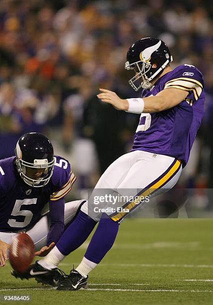 Ryan Longwell of the Minnesota Vikings kicks a field goal as Chris Kluwe holds in the fourth quarter against the Chicago Bears on November 29, 2009...