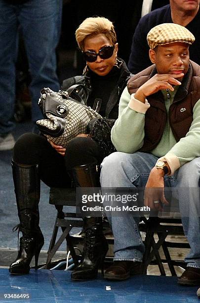 Singer Mary J. Blige and Kendu Isaacs watches on during the game between the Orlando Magic and the New York Knicks at Madison Square Garden November...