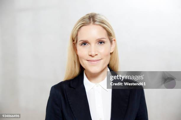 portrait of smiling blond businesswoman - transparent blouse stock pictures, royalty-free photos & images