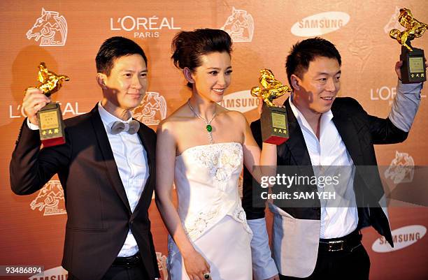 Hong Kong actor Nick Cheung, Chinese actress Li Bingbing and Chinese actor Huang Bo hold their trophies after winning the Best Leading Actor and...