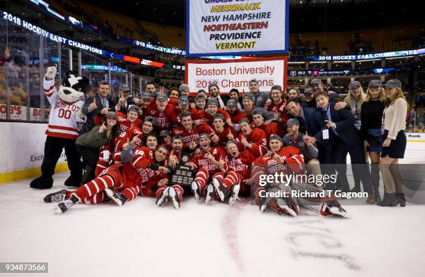 The Boston University Terriers pose with the Lamorillo Trophy after a game against the Providence College Friars during NCAA hockey in the Hockey...